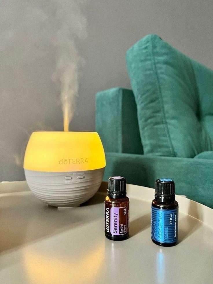 Essential oil bottles with lavender, sage and rose petals